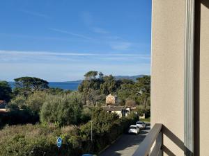 a view from a building with cars parked on a road at T2 à 200m des plages in Propriano