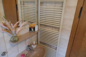 a bathroom with a sink and a window with shutters at theBlackwood in Todtnauberg +17 photos