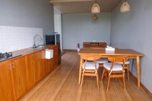 a kitchen with a wooden table and four chairs at Loka Shanti Mas in Mantaak +8 photos