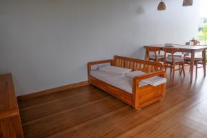 a bedroom with a bed and a table with chairs at Loka Shanti Mas in Mantaak