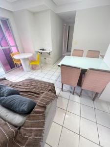 a living room with a couch and a table and chairs at Lar da Galega Espinheiro in Recife