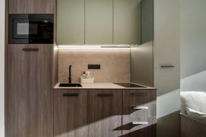 a kitchen with wooden cabinets and a sink at Résidence Freddie in Tignes +180 photos