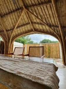 a room with two chairs and a wooden fence at Sea Turtle Villas in Gili Islands