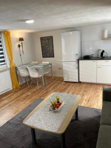 a living room with a table and a kitchen at Haus Almblick in Gasen