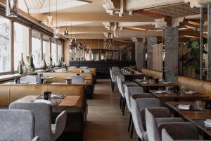 a dining room with wooden tables and chairs at VAYA Lechtal in Elbigenalp +78 photos