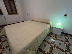 a bedroom with a bed with a lamp on it at Cassiopea in Isnello