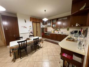 a kitchen with a table and some chairs in it at Cassiopea in Isnello +9 photos