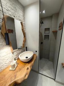 a bathroom with a sink and a shower at Corfu nest apartment in Ágios Rókkos