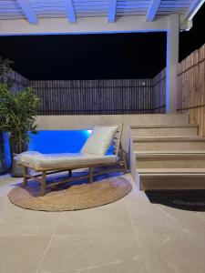 a bench sitting next to a pool with stairs at Shilo Boutiqe Suites in Mishmār Hāyardin
