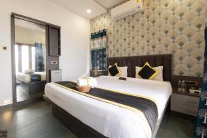 a bedroom with a large bed in a room at Reunion Ocean Hridayam - Beach House in Udupi