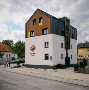 a building with a brown and white building at PENZIÓN u JAKUBA & REŠTAURÁCIA Bezplatné Parkovanie in Martin
