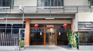 an entrance to a building with a sign on it at Kara Guest House AA1 in Batam Center