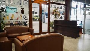 a store with two chairs and a table and a piano at Kara Guest House AA1 in Batam Center