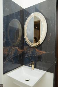 a bathroom with a sink and a mirror at Reunion Ocean Hridayam - Beach House in Udupi +31 photos