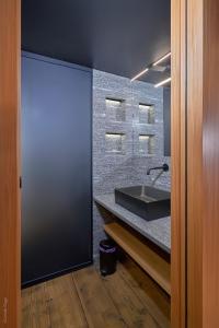 a bathroom with a sink and a black counter at BnB Ai Cav Calanca in Arvigo