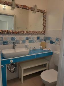 a bathroom with a sink and a toilet and a mirror at Al Passo di Thalia in Ricadi +118 photos