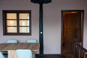 a dining room with a table and a pole at Αρχοντικό Παπαγιάννη in Edessa