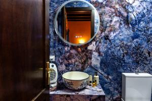 a bathroom with a sink and a mirror at Αρχοντικό Παπαγιάννη in Edessa +36 photos