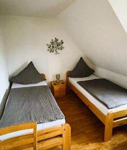 a room with two beds in a attic at Zum Seeweiher in Dreifelden