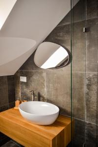 a bathroom with a white bowl sink and a mirror at Chata Zingoty in Mýto pod Ďumbierom +31 photos