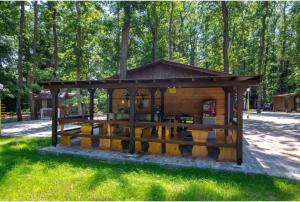 a small wooden building in the grass in a park at Elmona Villas in Kamchia