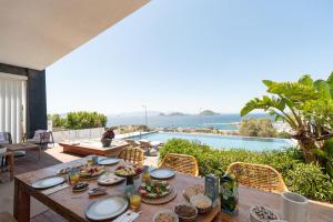 a dining table with food on a patio with a view of the ocean at Marinhill High Luxury Villa with Private Pool and Sea View in Bodrum City