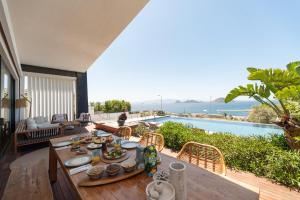 a dining room with a table and a view of the ocean at Marinhill High Luxury Villa with Private Pool and Sea View in Bodrum City