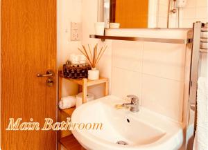 a bathroom with a white sink and a toilet at Peaceful 2 Bed Home with Parking Fast WIFI Easy Stress-Free Access to Bath in Bath +21 photos