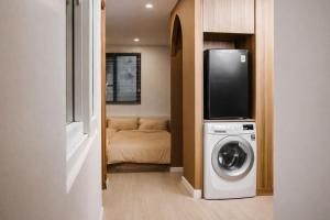 a living room with a washing machine and a tv at AimeeHouse - Trích Sài in Hanoi +57 photos
