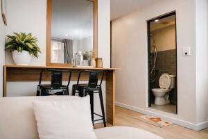 a bathroom with a toilet and a counter with stools at AimeeHouse - Trích Sài in Hanoi
