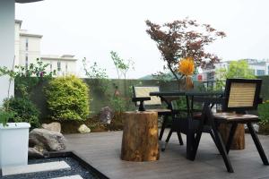 a patio with a table and chairs on a deck at Good Night Hotel in Zhangjiajie