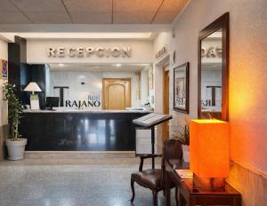 an office with a reception desk and a mirror at Hotel Trajano in Zalamea de la Serena