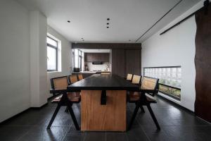 a dining room with a wooden table and chairs at Good Night Hotel in Zhangjiajie