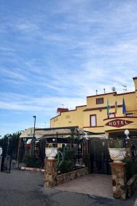a hotel with a sign on the front of a building at Hotel Trajano in Zalamea de la Serena