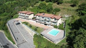 an aerial view of a house with a swimming pool at Balconi sul Lago - Stunning Lakeview and Pool in Parzanica