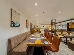 a dining room with a long table and chairs at Zip By Spree Hotels Chakan, Pune in Pune