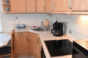 a kitchen with a sink and a counter top at Bernstein Mare-Supreme Wohnung 4 in Büsum