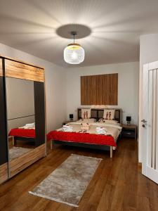 a bedroom with two beds and a mirror at Stadium Central Apartment Residence & terrace in Craiova