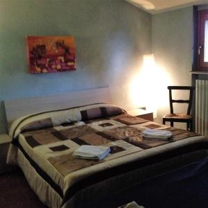 En eller flere senge i et værelse på Cascina Garaita