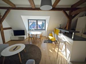 a kitchen and living room with a table and chairs at APARTMÁNY 91 Boží Dar in Boží Dar
