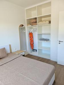 a bedroom with a bed and a closet at Friendly & Warm in Tamarin