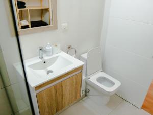 a bathroom with a sink and a toilet at Friendly & Warm in Tamarin +3 photos