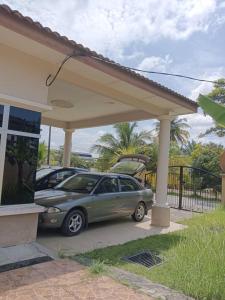 a car parked under a carport in a house at SemiD in Batu Kikir