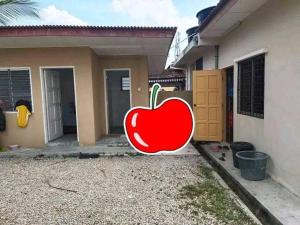 a large red apple painted on the side of a house at SemiD in Batu Kikir