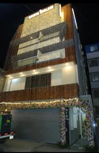 a building with a lot of flowers on the side of it at Sathya Comforts in Bangalore