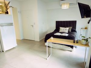 a room with a bed and a table in it at Depto H in Buenos Aires +11 photos