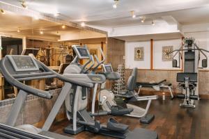a gym with treadmills and elliptical machines at Hôtel Atala Champs Elysees in Paris