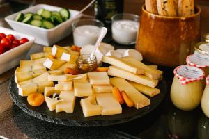 a plate of cheese and vegetables on a table at Hôtel Atala Champs Elysees in Paris