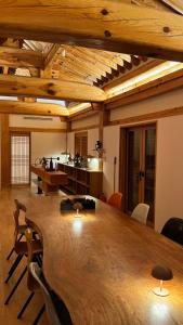 a conference room with a large wooden table and chairs at soyeonjae 소연재 in Gyeongju