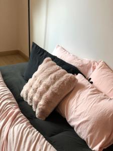 a pile of pillows sitting on top of a bed at Nhà 5 PM in Da Thien